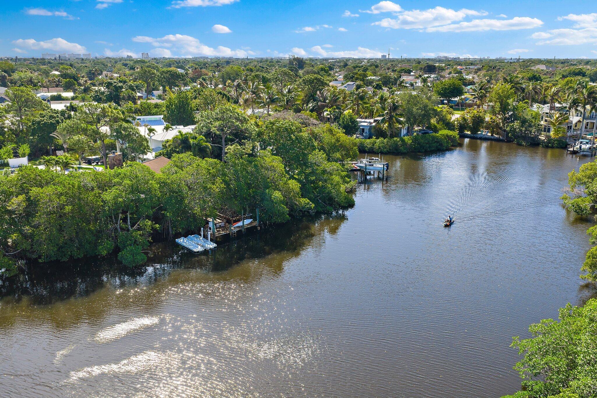 702 Warren Drive Jupiter, FL 33458 - Photo 59 of 76 an aerial view of a houses with a lake view
