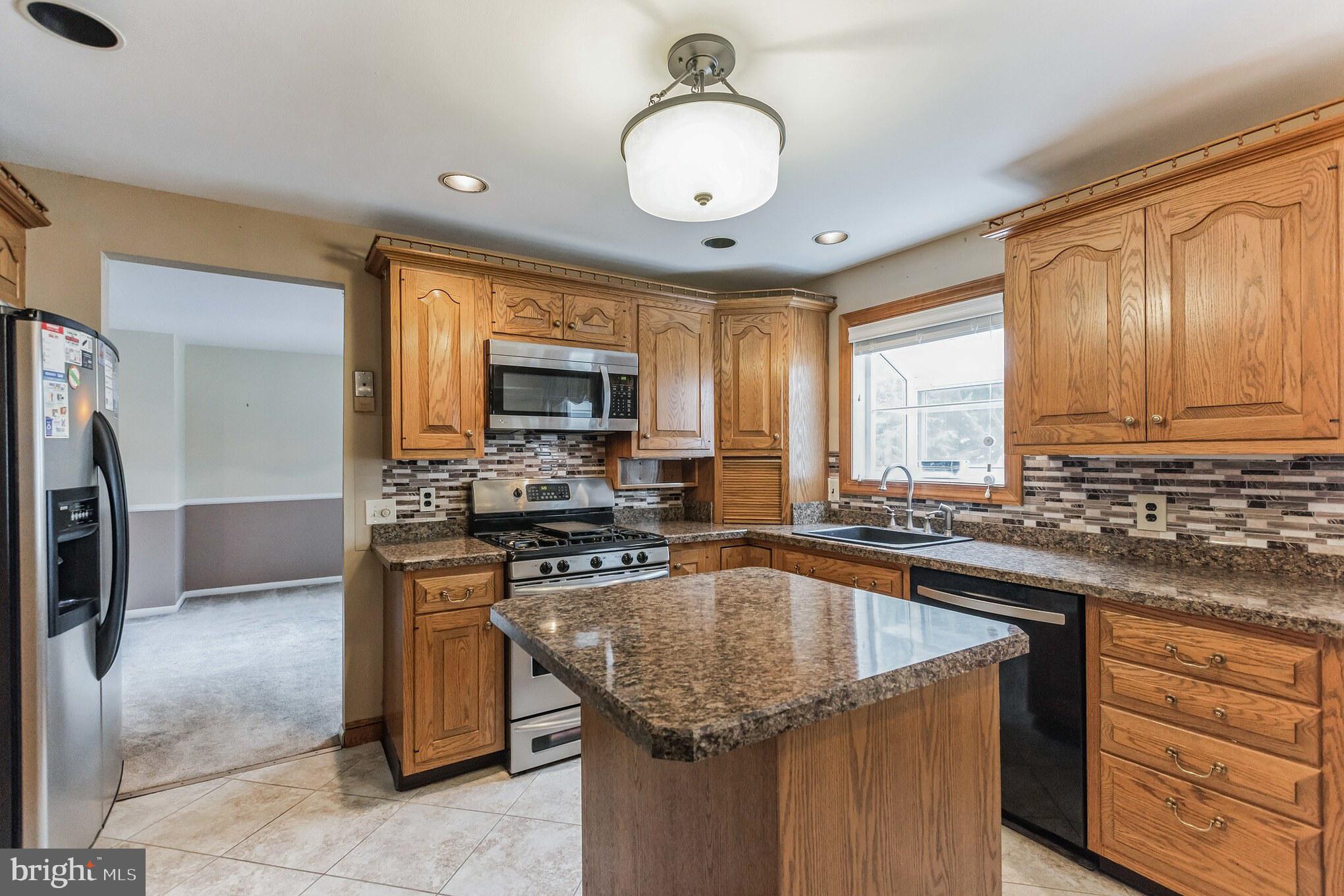19 Candlestick Road Clementon, NJ 08021 - Photo 11 of 32 a kitchen with a stove a sink a microwave and cabinets