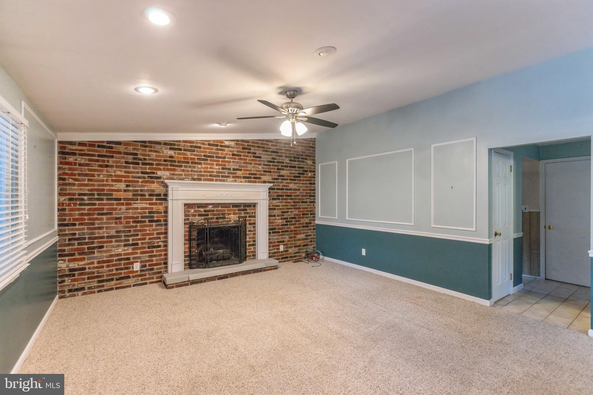 19 Candlestick Road Clementon, NJ 08021 - Photo 16 of 32 a view of a livingroom with a fireplace a ceiling fan and closet