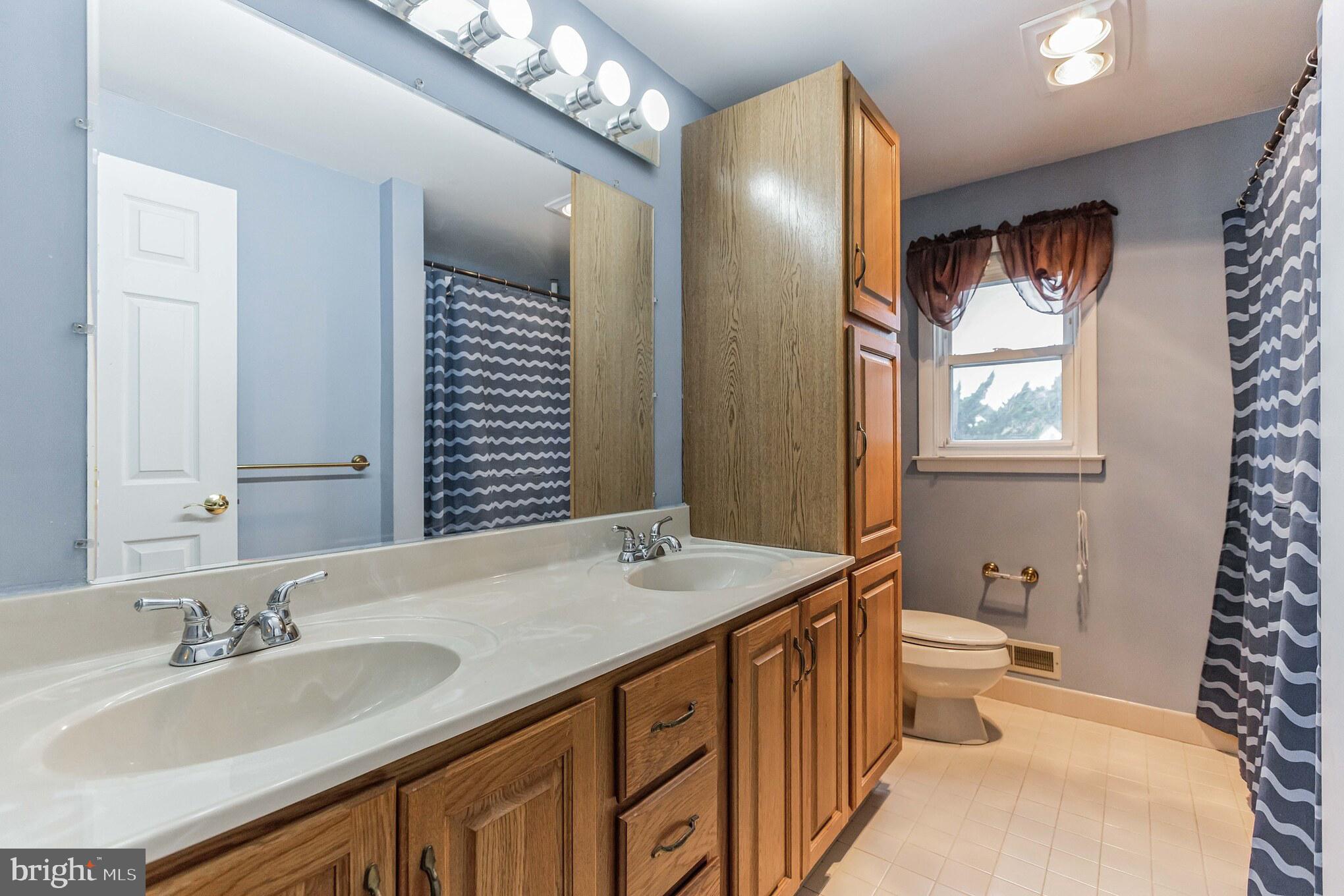 19 Candlestick Road Clementon, NJ 08021 - Photo 26 of 32 a bathroom with a granite countertop sink a toilet a mirror and shower