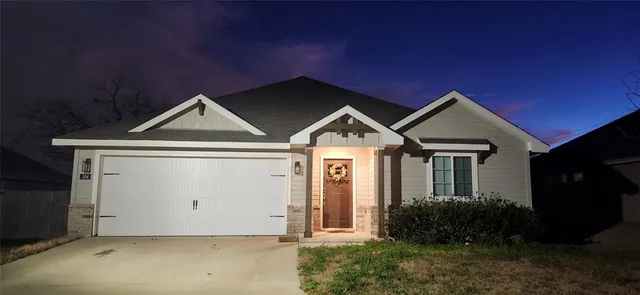 a front view of a house with yard