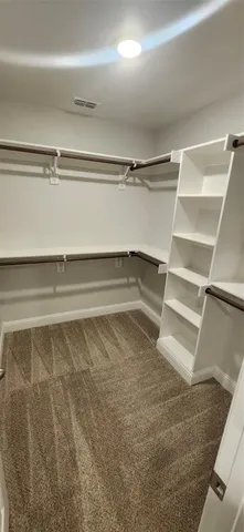 a kitchen with stainless steel appliances a refrigerator stove and wooden floor