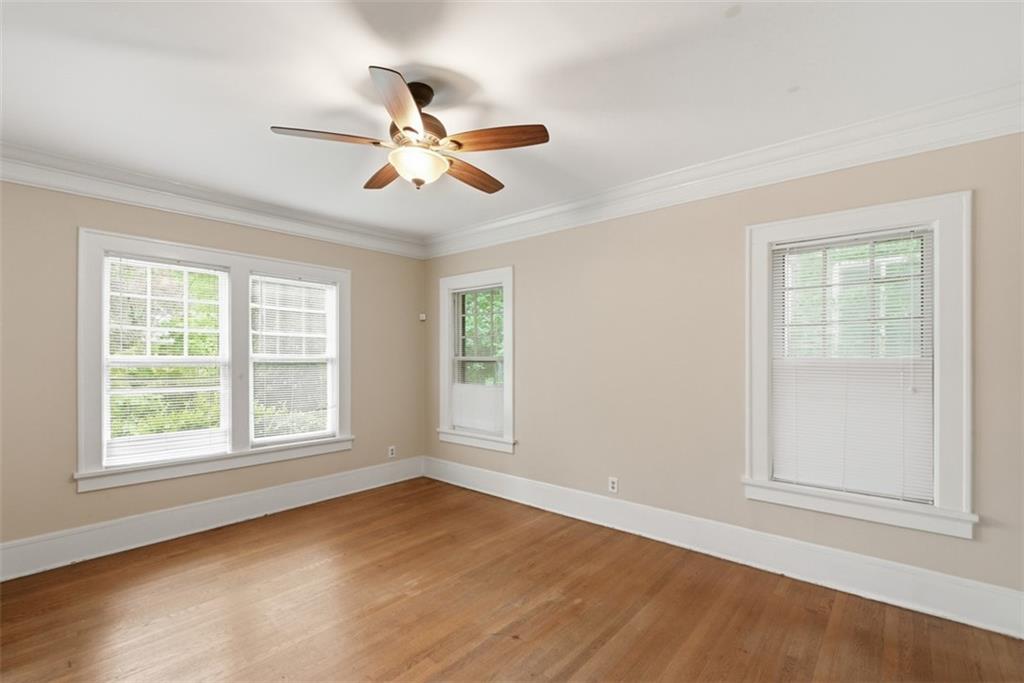 1424 Emory Road Northeast Atlanta, GA 30306 - Photo 10 of 36 a view of an empty room with wooden floor and a window