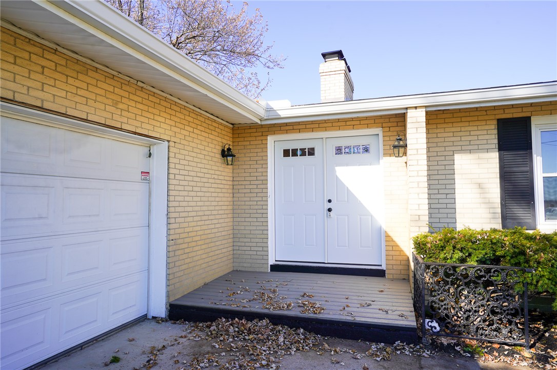 8746 Grubbs-Rex Road Arcanum, OH 45304 - Photo 2 of 38 This charming residence features a welcoming entrance with a classic brick exterior and a practical attached garage.