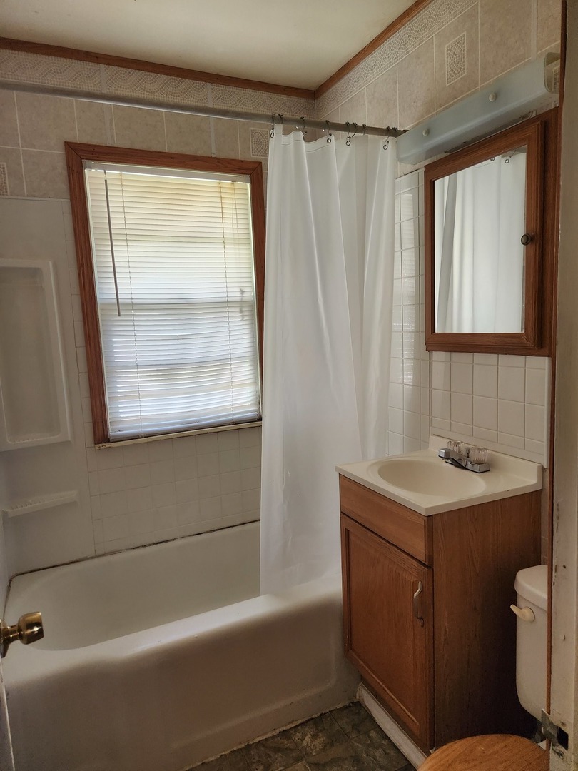 1228 20th Street North Chicago, IL 60064 - Photo 12 of 14 a bathroom with a sink toilet and tub