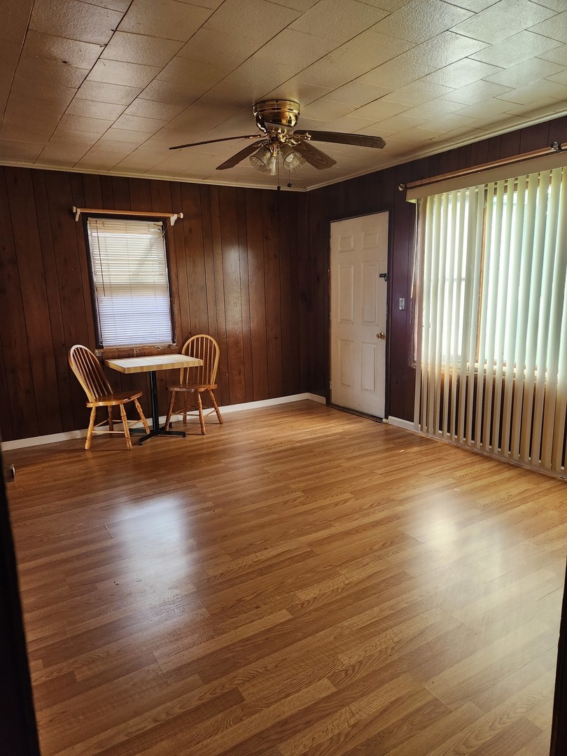 1228 20th Street North Chicago, IL 60064 - Photo 7 of 14 an empty room with wooden floor and windows