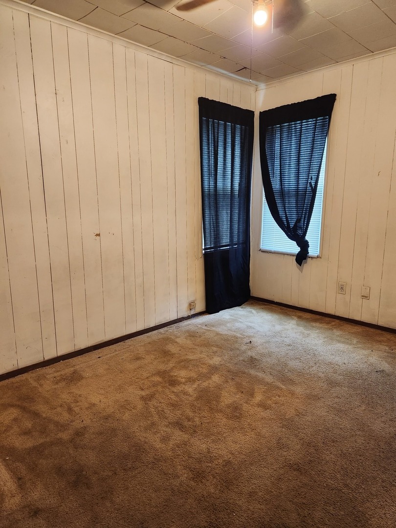 1228 20th Street North Chicago, IL 60064 - Photo 9 of 14 a view of an empty room with wooden floor and a window
