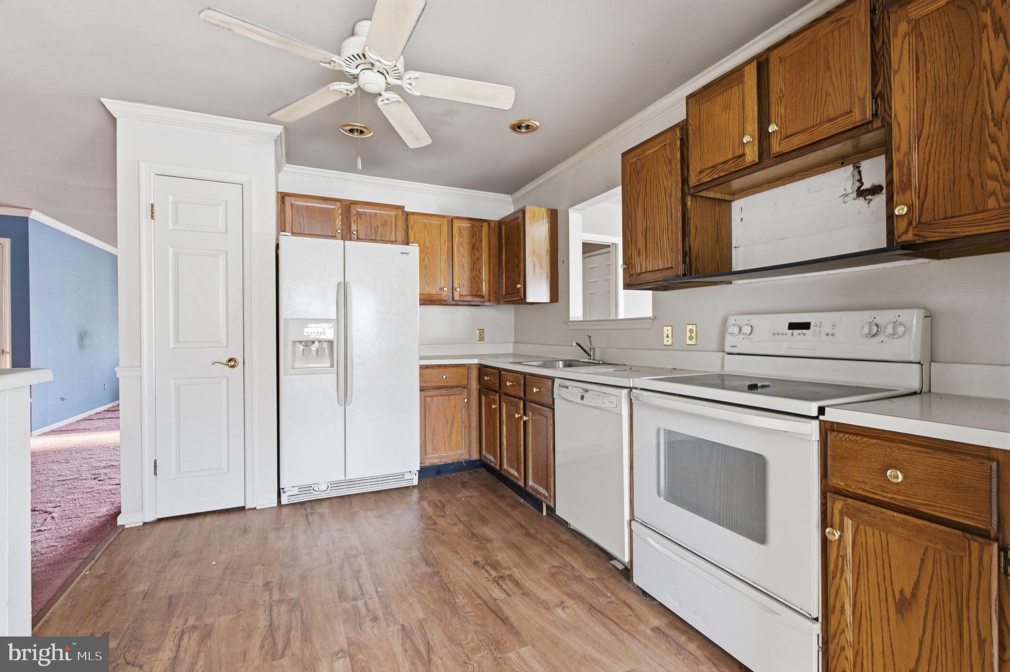 1997 Brook Lane Jamison, PA 18929 - Photo 5 of 19 a kitchen with stainless steel appliances white cabinets and wooden floors