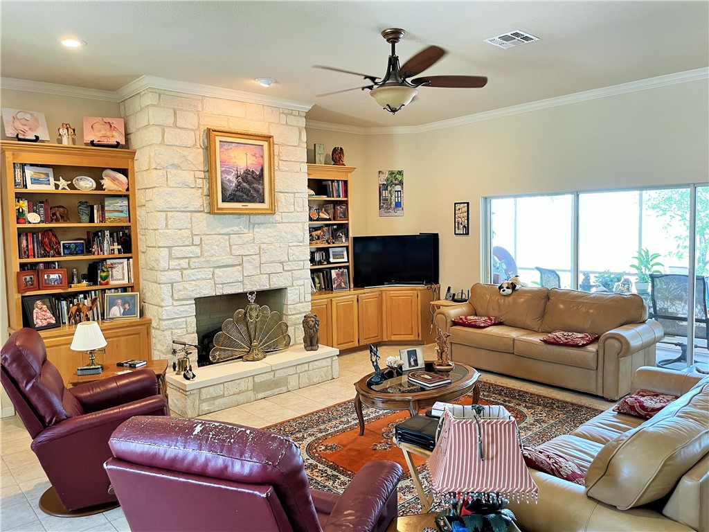 17452 Deer Ridge Road Moody, TX 76557 - Photo 19 of 60 a living room with furniture a flat screen tv and a fireplace