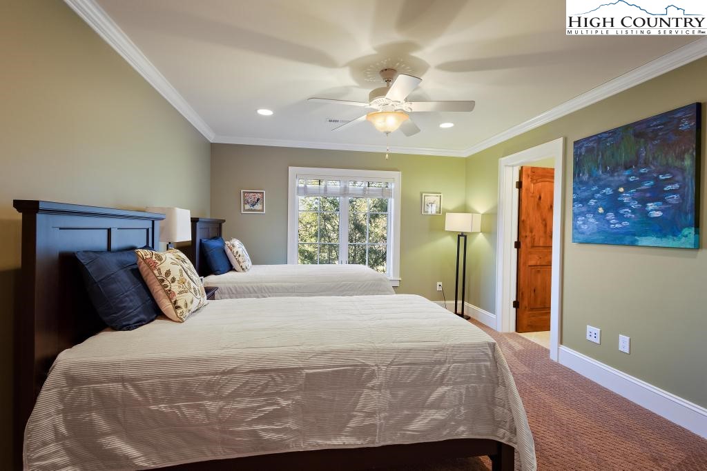 766 Turtle Creek Drive, Unit 3A Boone, NC 28607 - Photo 26 of 46 a bedroom with a large bed and a chandelier