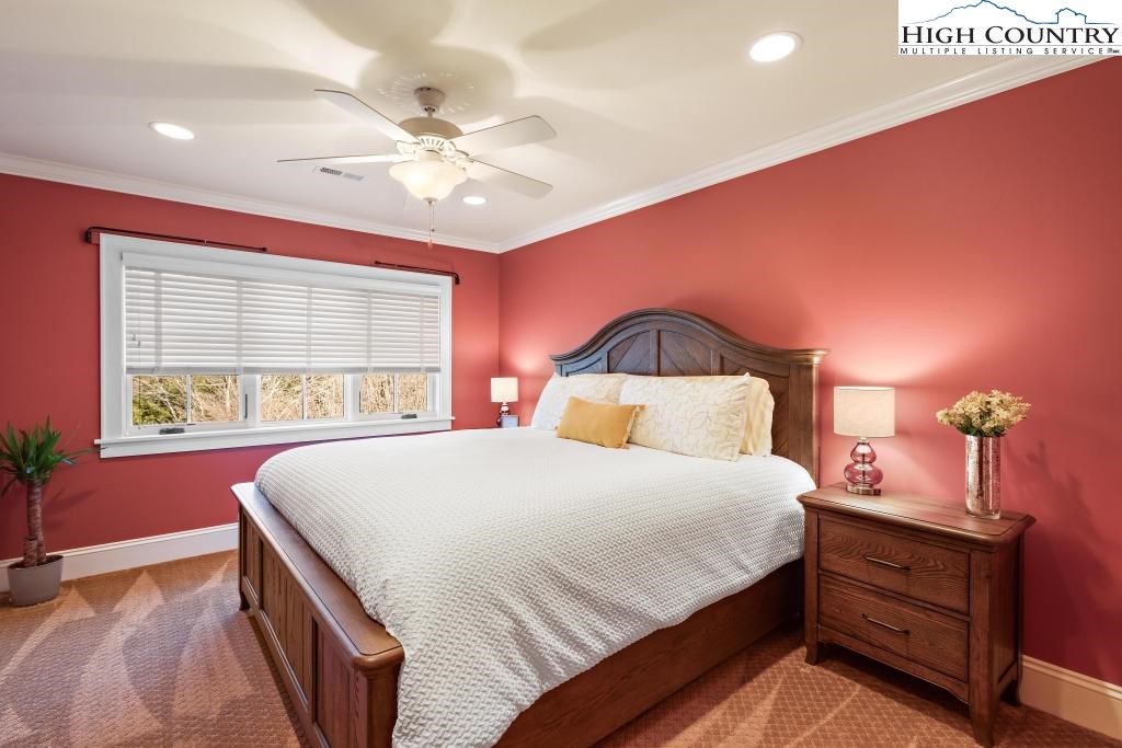 766 Turtle Creek Drive, Unit 3A Boone, NC 28607 - Photo 31 of 46 a bedroom with a large bed and a chandelier