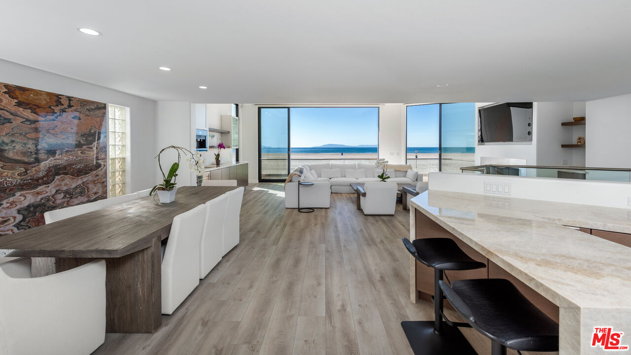 3461 Ocean Drive Oxnard, CA 93035 - Photo 7 of 30 a large kitchen with kitchen island a wooden floor and living room