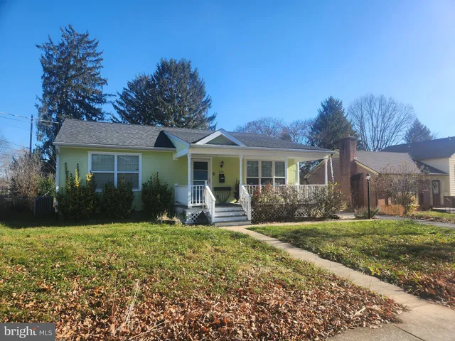 a front view of a house with a yard and porch