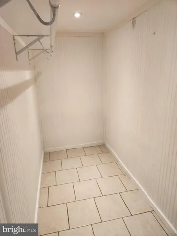a view of a room with white tiles