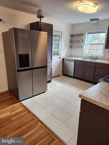 a kitchen with stainless steel appliances a refrigerator sink and cabinets