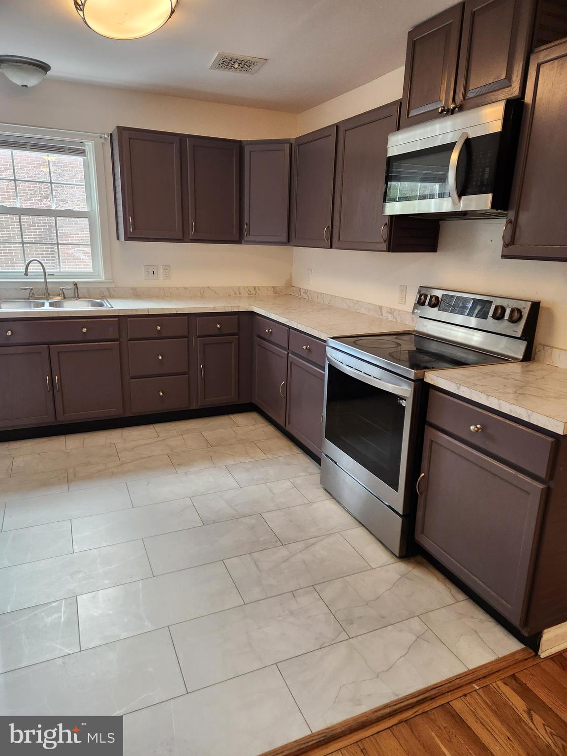 501 South Seminary Street Charles Town, WV 25414 - Photo 4 of 18 a kitchen with stainless steel appliances granite countertop a stove a sink and a microwave