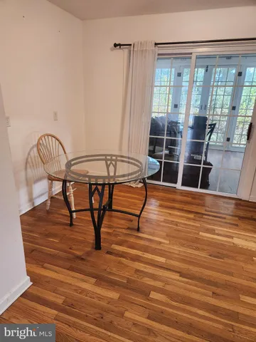 a view of a room with furniture wooden floor and window
