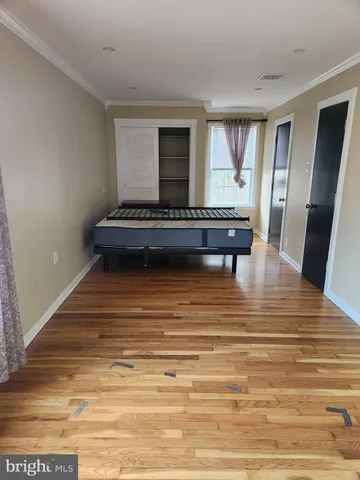 a view of a room with furniture and wooden floor