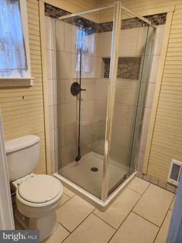 a bathroom with a shower and a toilet