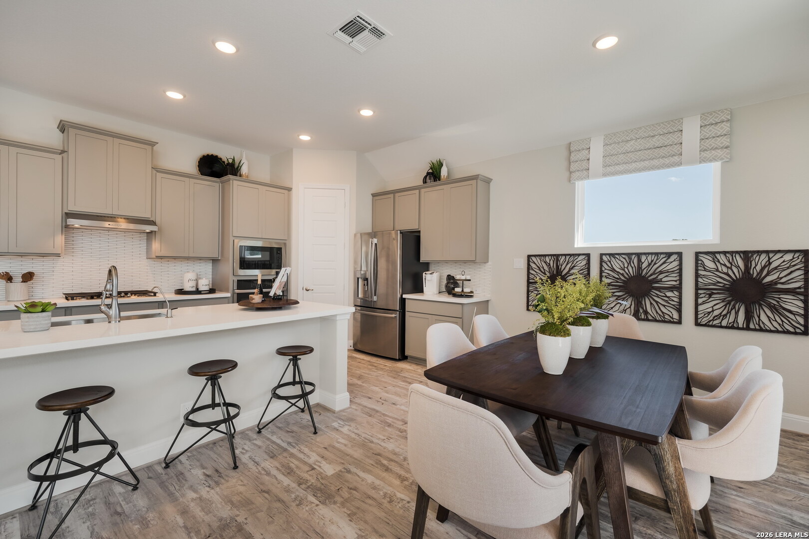 417 Fandango Boerne, TX 78006 - Photo 12 of 37 a kitchen with a dining table chairs and white appliances