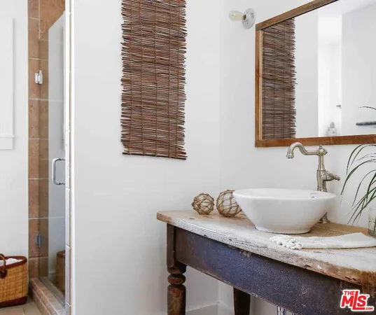 a bath room with a table and a potted plant