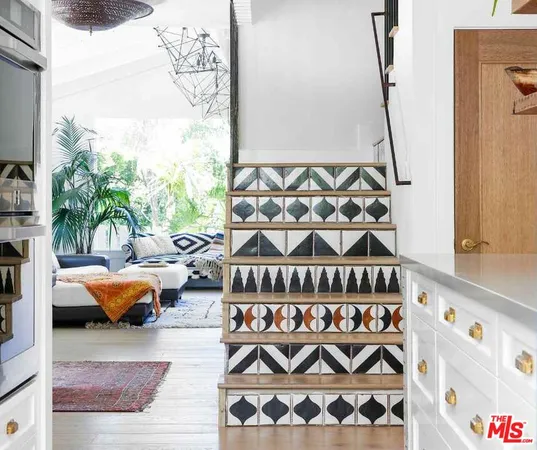 a bedroom with furniture and a painting on the wall