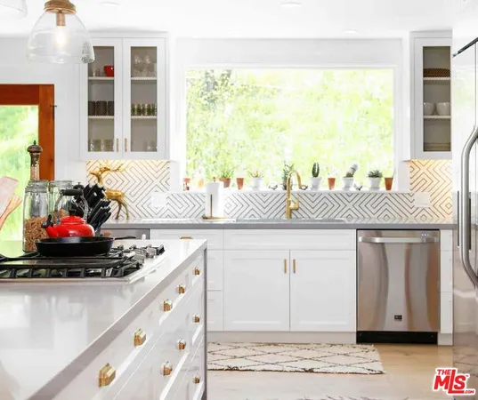 a kitchen with a sink cabinets and a large window