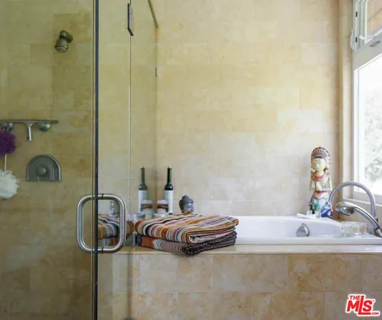 a living room with furniture a flat screen tv and a floor to ceiling window