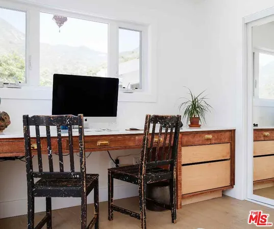 a view of a backyard with plants and a patio