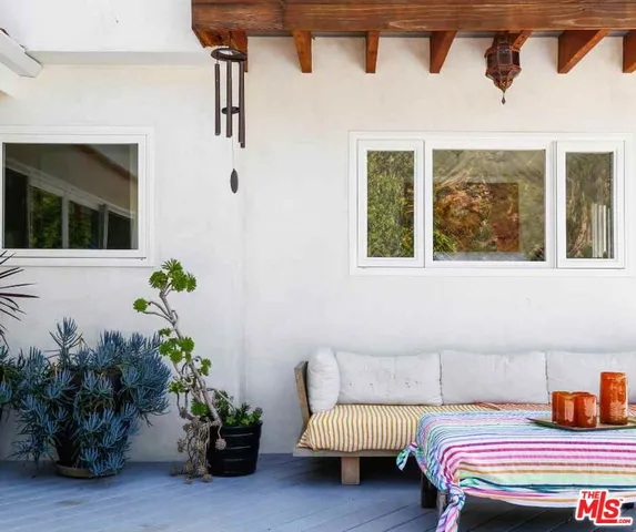 a bedroom with a bed potted plant and a window