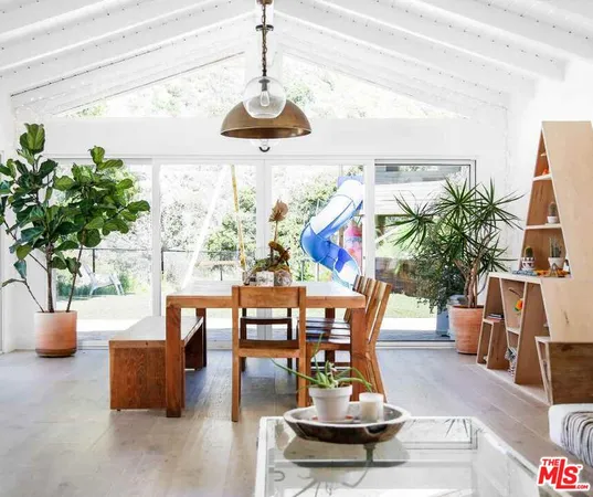 a view of a dining room with furniture a chandelier and wooden floor