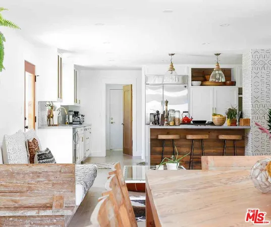 a living room with stainless steel appliances kitchen island granite countertop furniture and a kitchen view