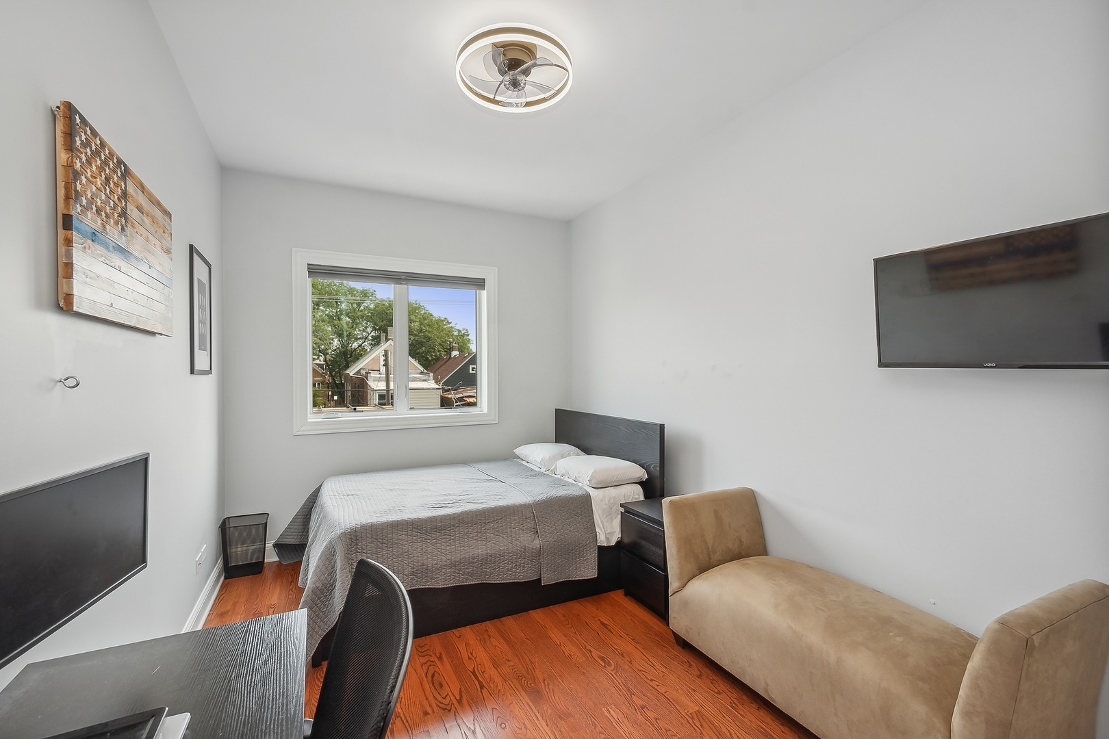 3301 South Racine Avenue Chicago, IL 60608 - Photo 15 of 32 a bedroom with a bed and a flat screen tv