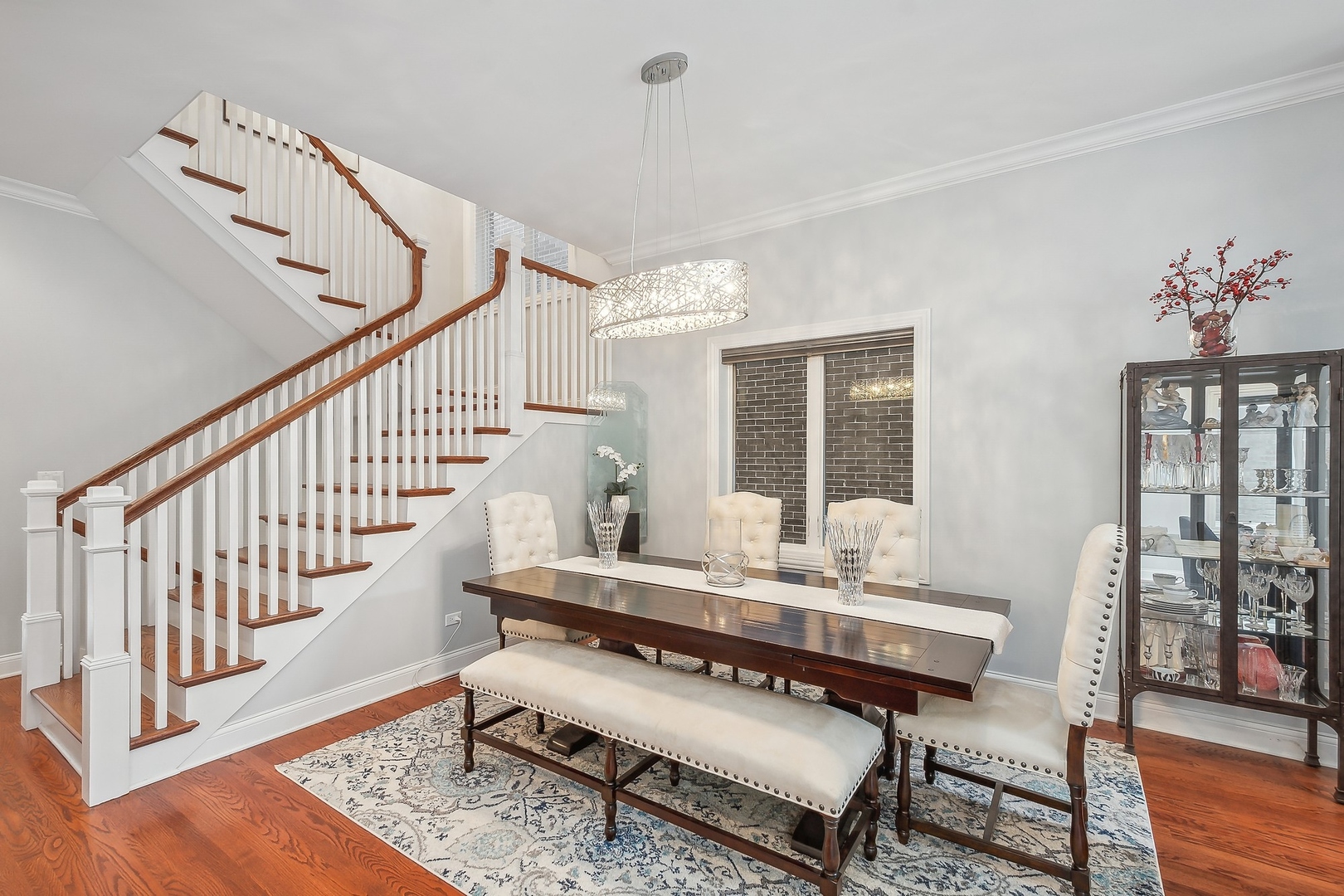3301 South Racine Avenue Chicago, IL 60608 - Photo 7 of 32 a dining room with wooden floor a chandelier a wooden table and chairs