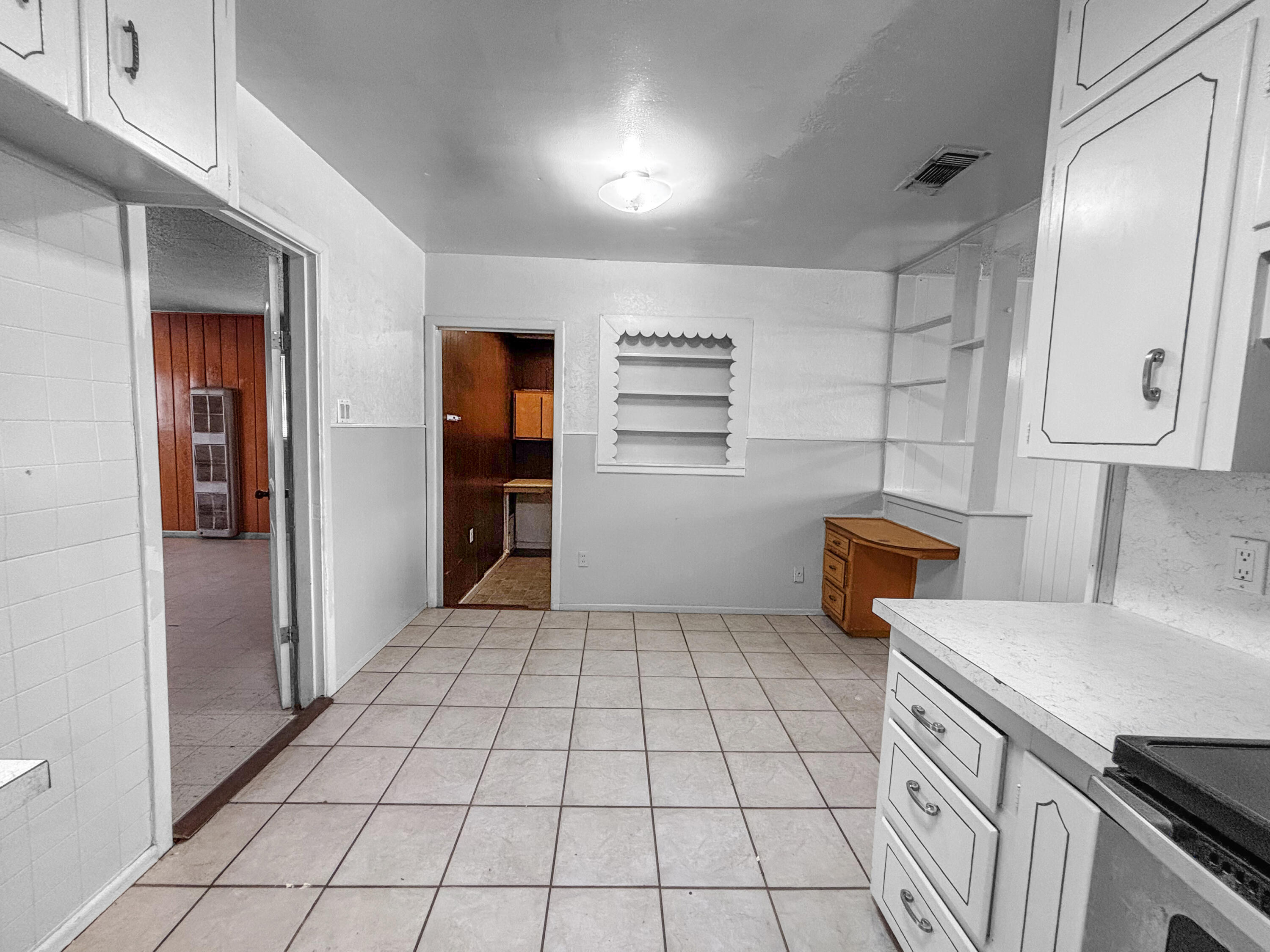 4411 45th Street Lubbock, TX 79414 - Photo 13 of 44 a kitchen with a sink a stove and refrigerator