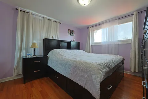 a bedroom with a bed and a mirror