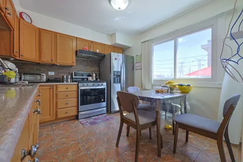 a kitchen with granite countertop a sink a stove and cabinets