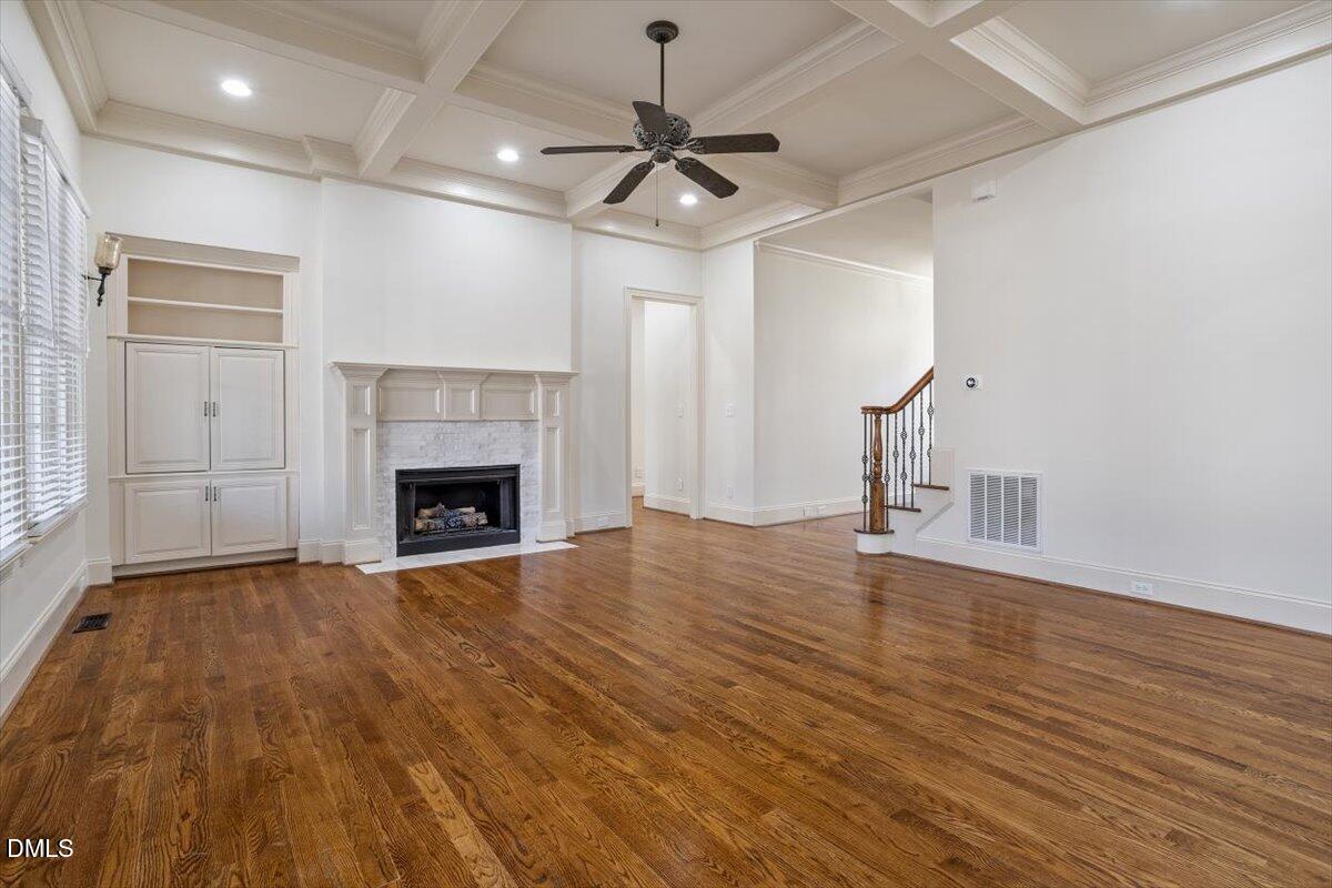 12820 River Dance Drive Raleigh, NC 27613 - Photo 11 of 86 a view of empty room with wooden floor and fireplace