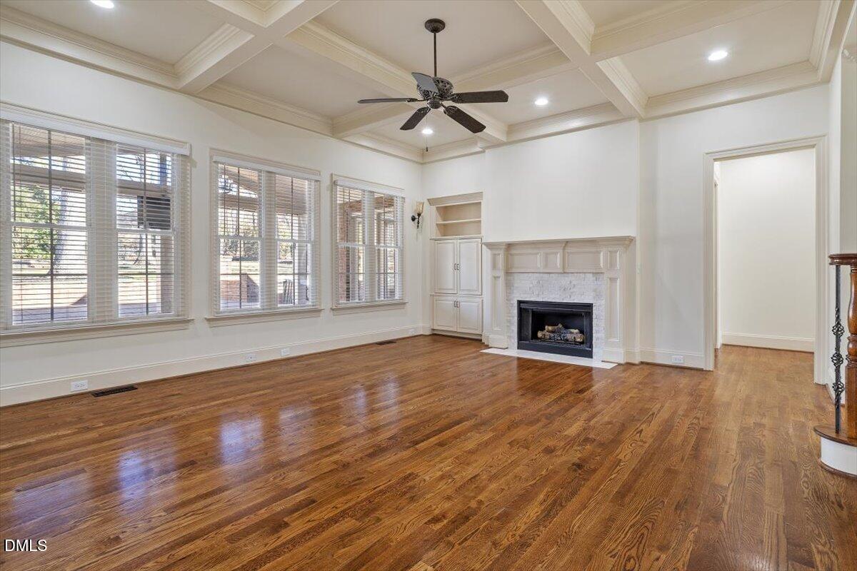 12820 River Dance Drive Raleigh, NC 27613 - Photo 13 of 86 a view of an empty room with wooden floor fireplace and a window