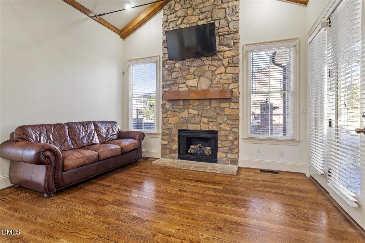 12820 River Dance Drive Raleigh, NC 27613 - Photo 16 of 86 a living room with furniture a flat screen tv and a fireplace