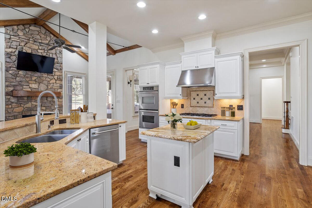 12820 River Dance Drive Raleigh, NC 27613 - Photo 19 of 86 a kitchen with a sink stove and refrigerator
