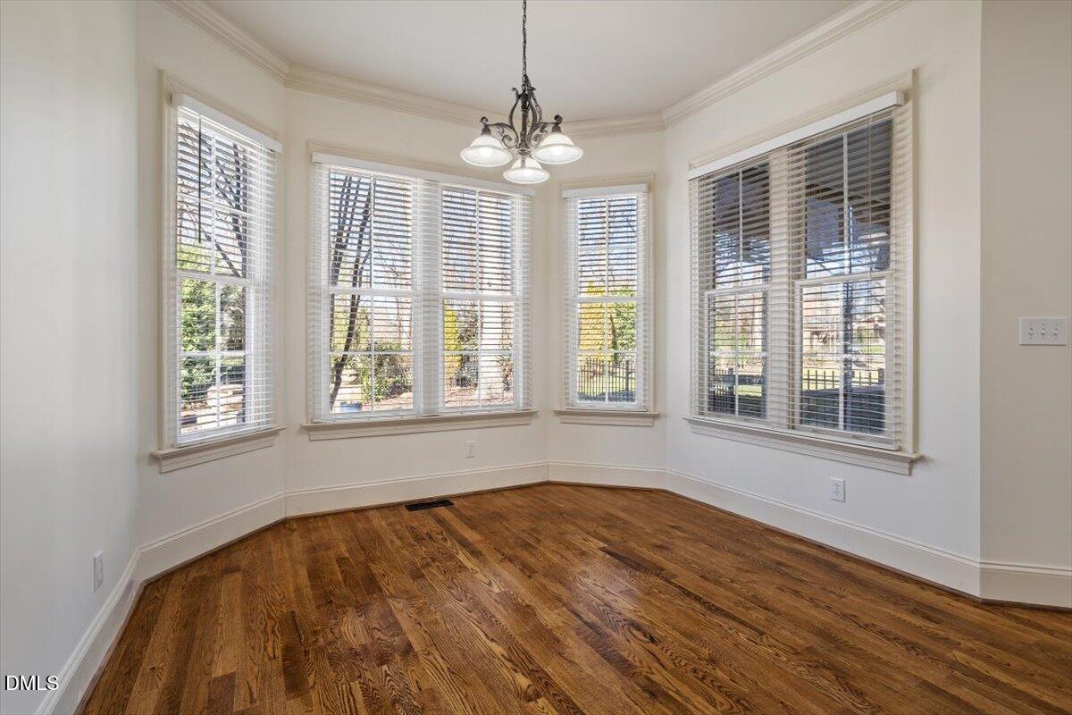 12820 River Dance Drive Raleigh, NC 27613 - Photo 25 of 86 a view of an empty room with wooden floor and a window