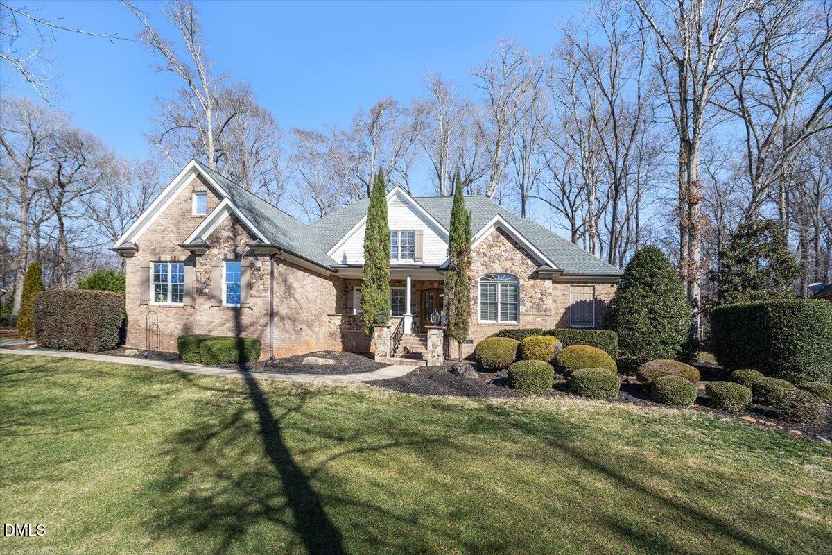 12820 River Dance Drive Raleigh, NC 27613 - Photo 2 of 86 a front view of house with yard and trees in the background