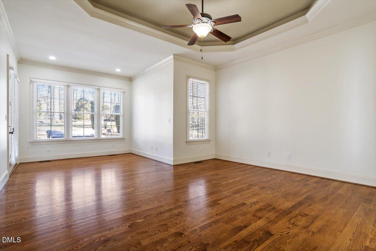 12820 River Dance Drive Raleigh, NC 27613 - Photo 30 of 86 a view of an empty room with window and wooden floor