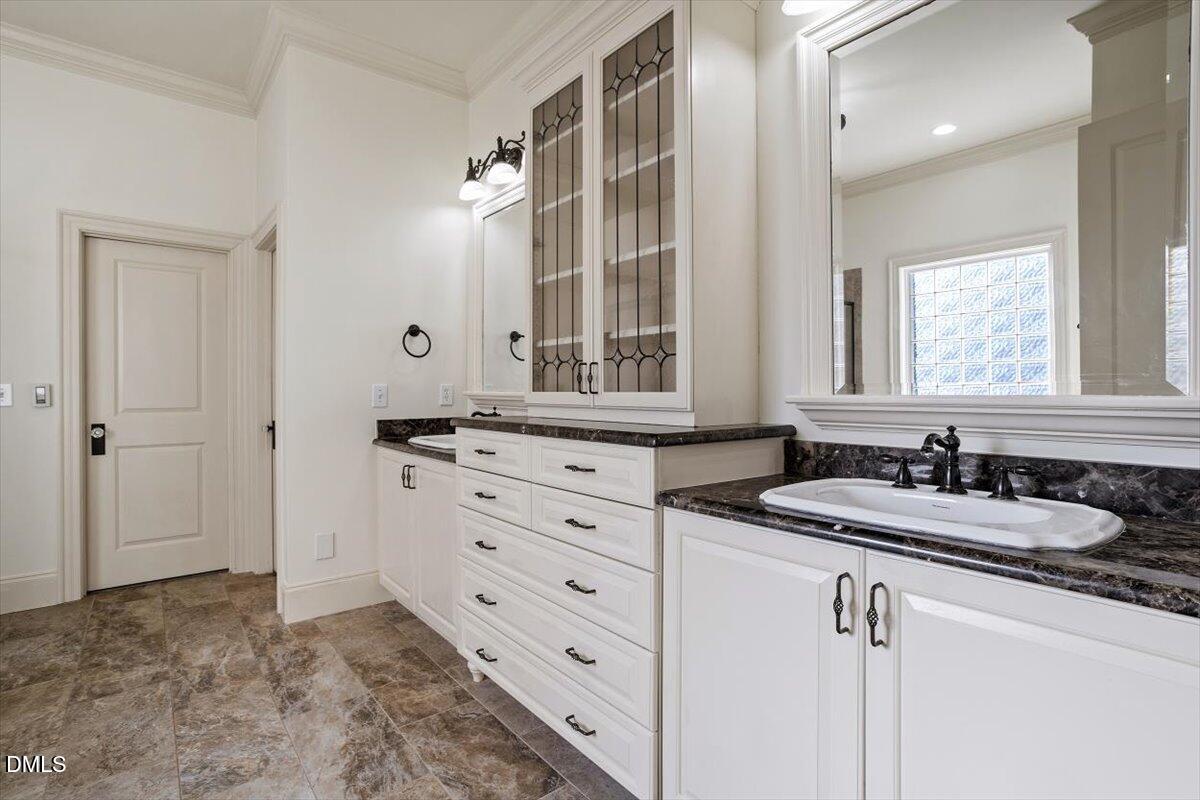 12820 River Dance Drive Raleigh, NC 27613 - Photo 33 of 86 a bathroom with a sink and a mirror