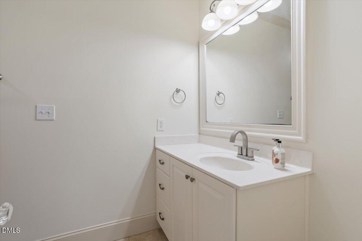 12820 River Dance Drive Raleigh, NC 27613 - Photo 45 of 86 a bathroom with a sink and a mirror