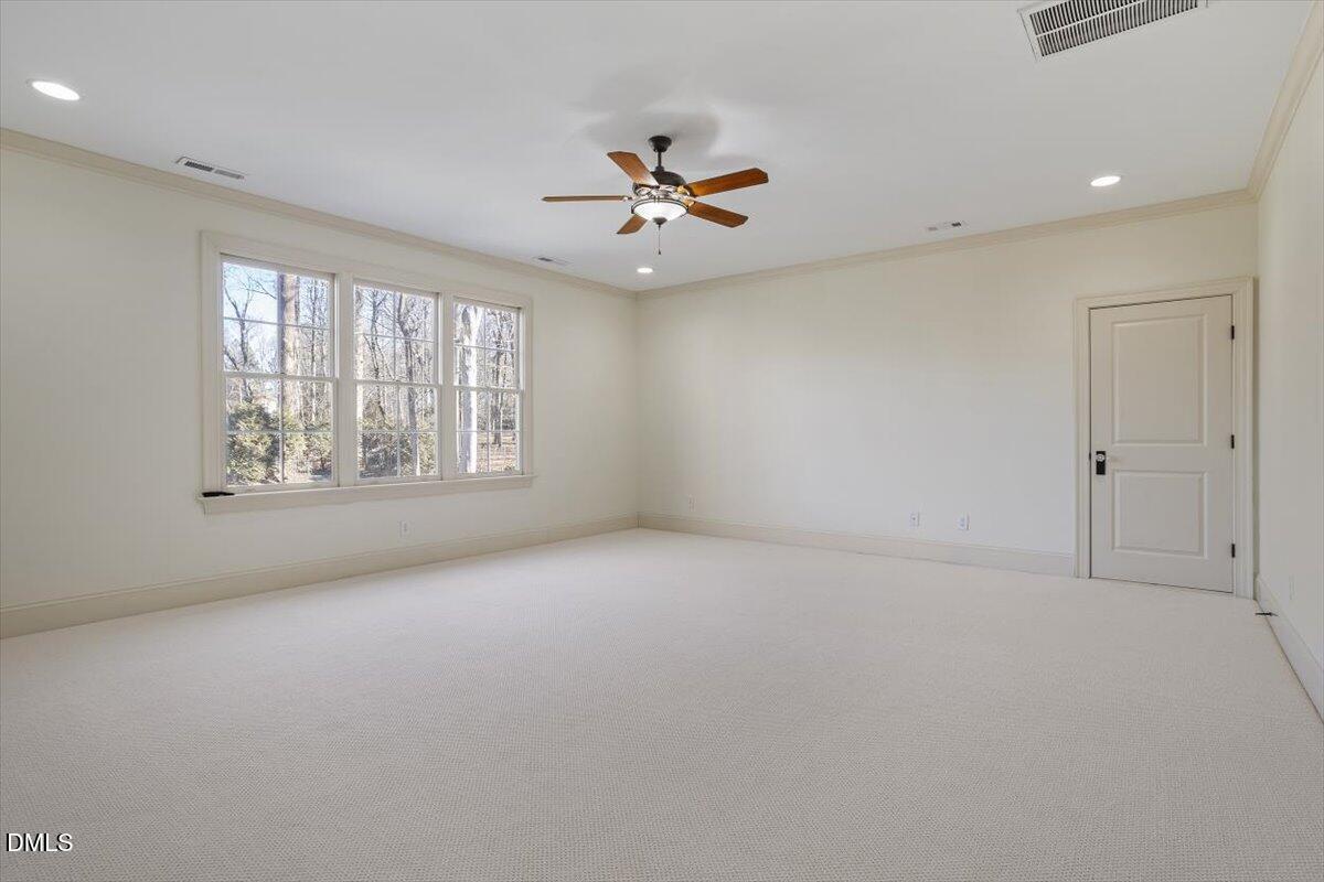 12820 River Dance Drive Raleigh, NC 27613 - Photo 51 of 86 an empty room with windows and ceiling fan