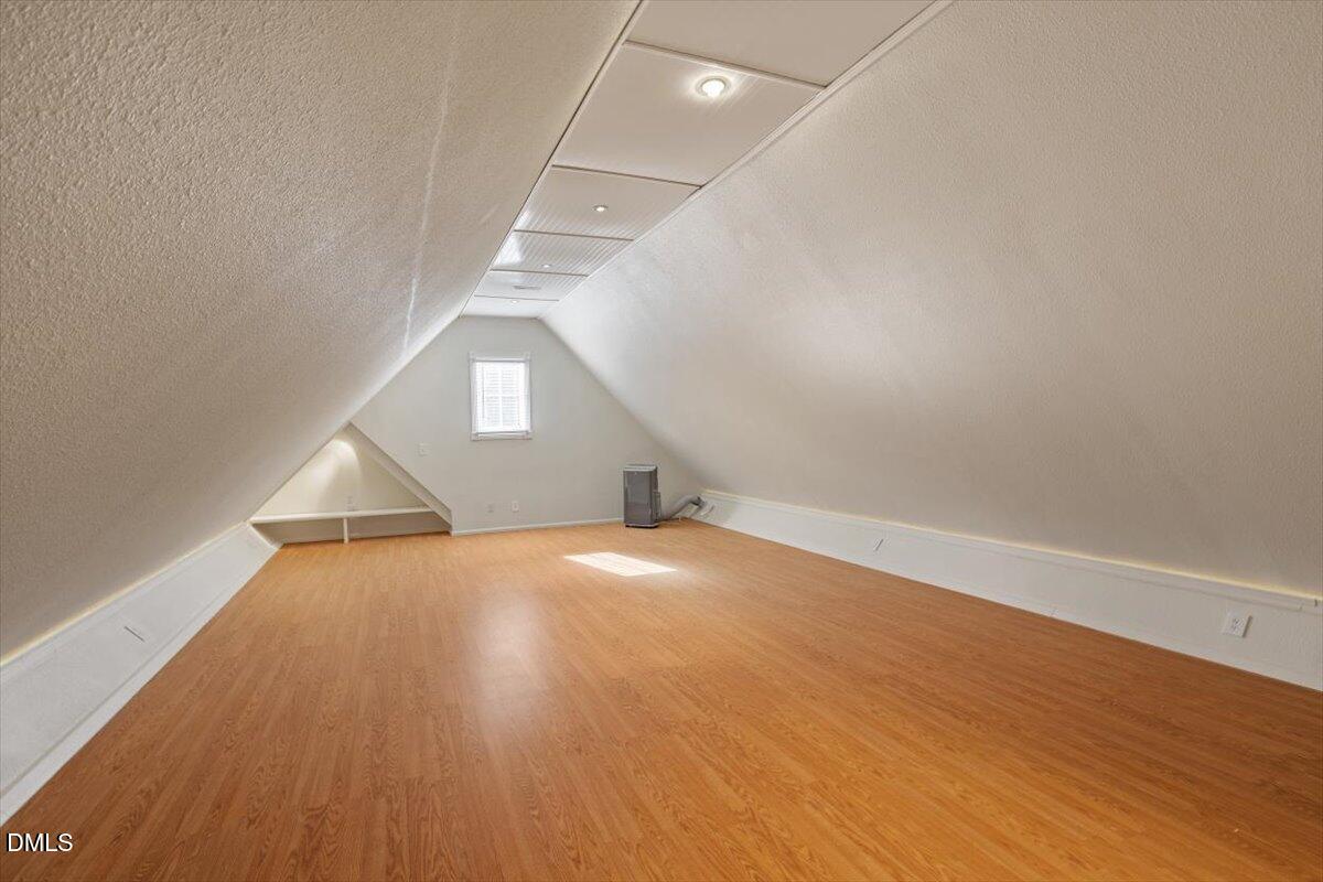 12820 River Dance Drive Raleigh, NC 27613 - Photo 56 of 86 an empty room with wooden floor and windows