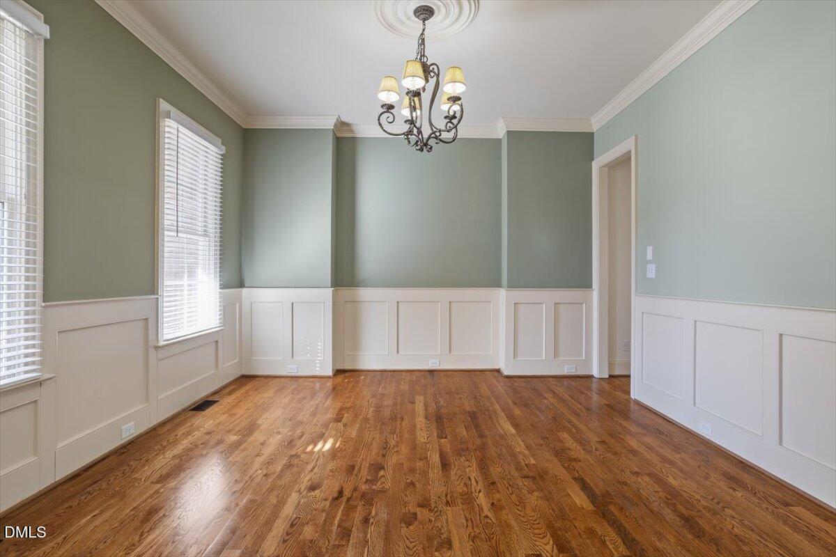 12820 River Dance Drive Raleigh, NC 27613 - Photo 7 of 86 a view of empty room with wooden floor and fan