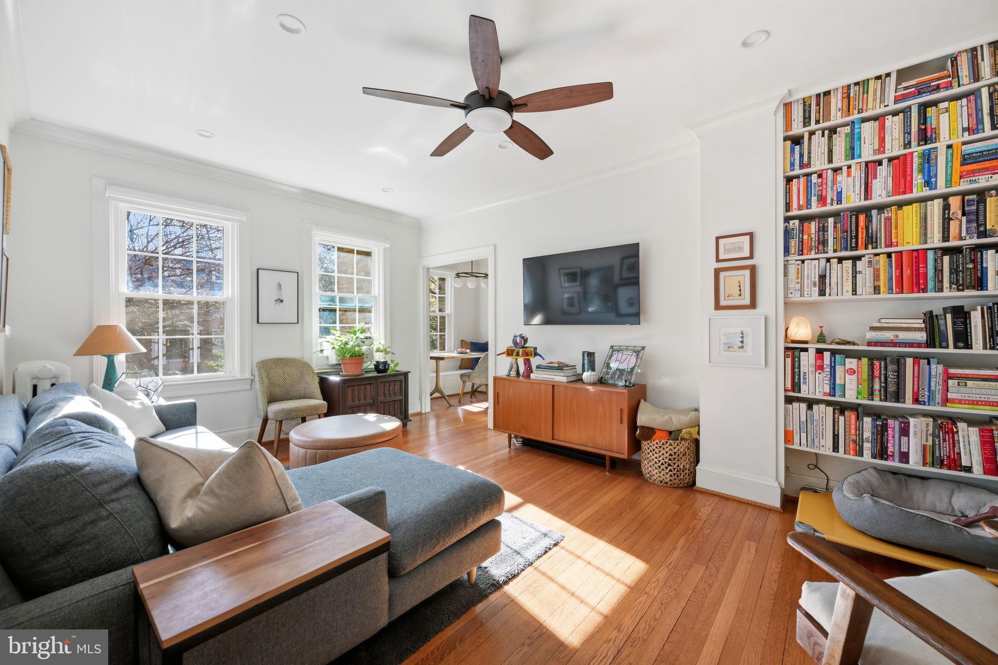 a living room with furniture furniture and a book shelf